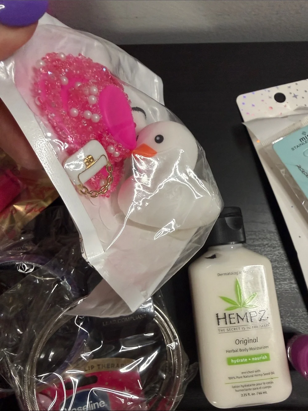 Clear Cosmetic Pouch with Hot Pink Trim and Pom Charm filled with goodies